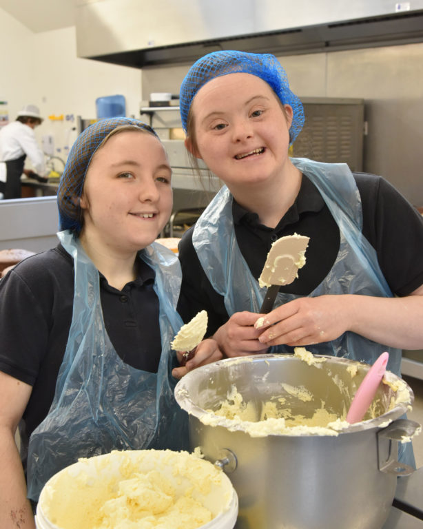 two students making a cake