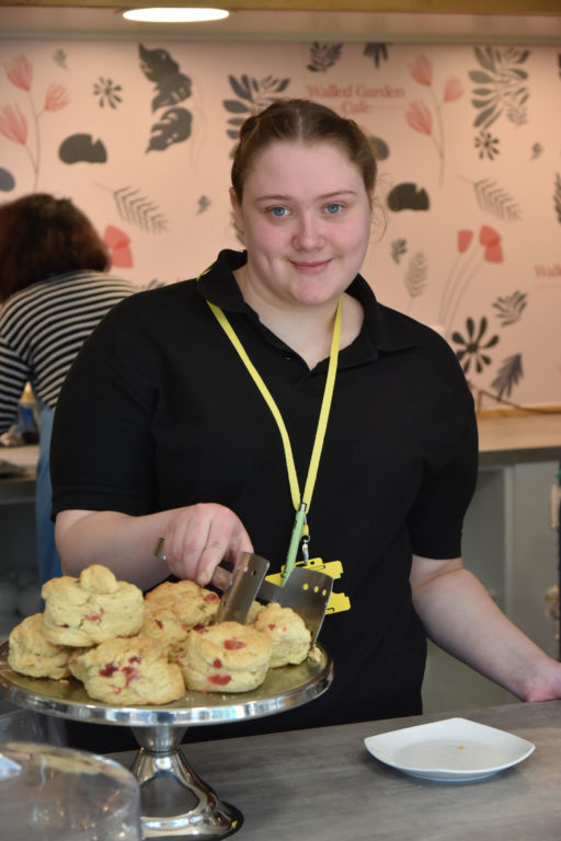 student serving a cake